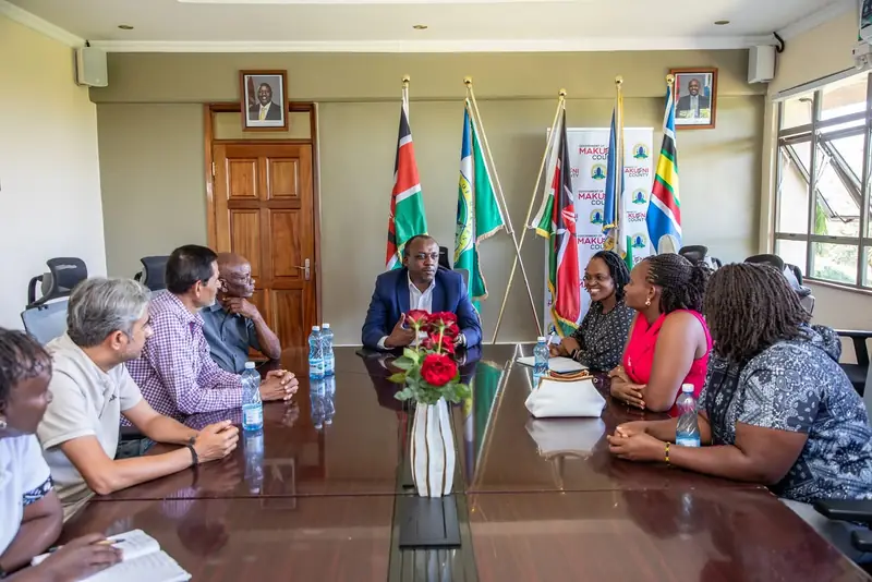 Governor Mutula Kilonzo Jr. meeting mango exporters and county representatives around a conference table.